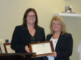 Minister Stefanson presents a certificate of appreciation to Darlene Hedgecock, for her assistance with the Civilian Monitor program